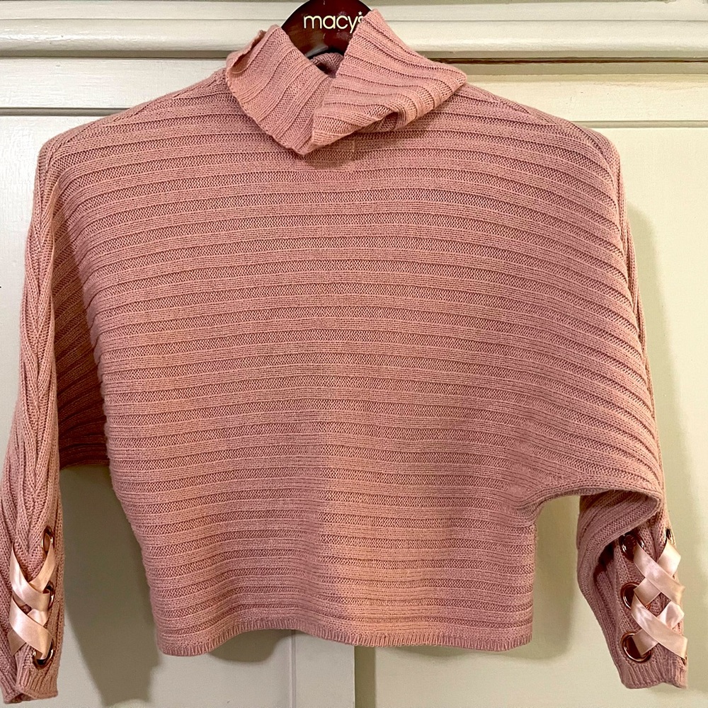 Cozy pink ribbed turtleneck sweater.
